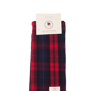 May include: Red and black tartan scarf with fringe. The scarf has a label that says "MacLachlan Modern" and "Luxury Tartan Clan Scarf".