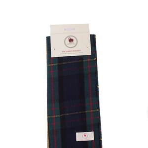 May include: A green, blue, red, and yellow plaid scarf with fringe. The scarf has a tag that reads "Maclaren Modern 3-Piece Tartan Clan Scarf".