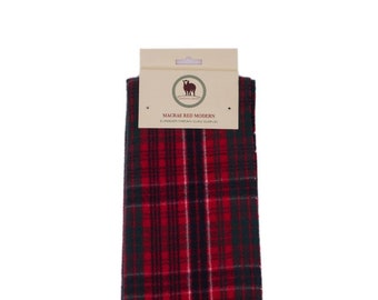 May include: Red and black plaid scarf with fringe. The scarf has a label that reads "MacRae Red Modern" and "Pure-Woven Tartan Clan Scarves".