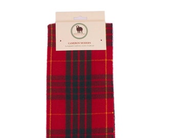 May include: Red, green, and yellow plaid scarf with fringe. The scarf has a tag that reads "Cameron Modern" and "Authentic Scottish Clan Scarves".