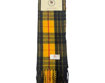 May include: A yellow, black, and red plaid scarf with a fringe. The scarf has a label that says "MacLeod Dress" and a small sheep logo.