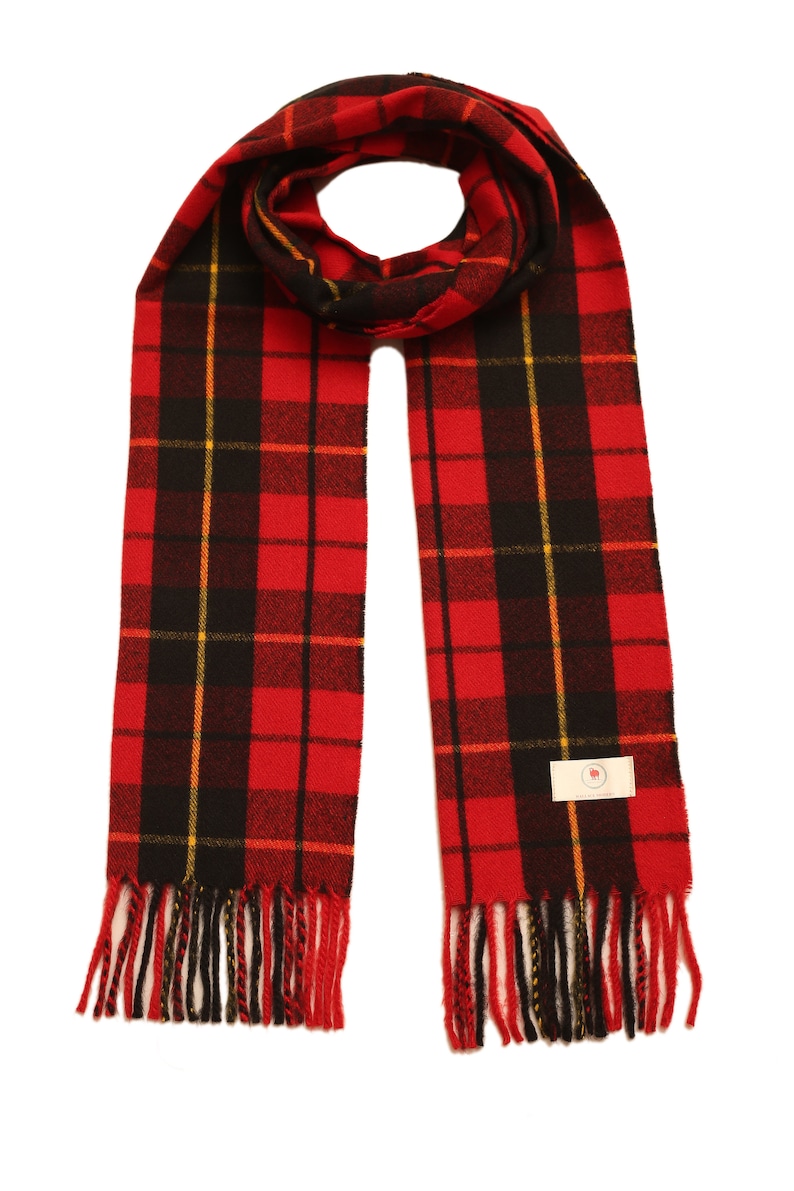 May include: Red, black, and yellow plaid scarf with fringe. The scarf has a small white tag with a red logo.