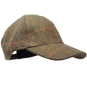 May include: A brown and green tweed baseball cap with a red and orange plaid pattern.