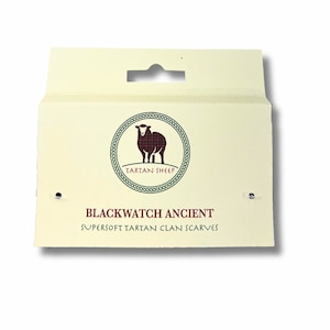 May include: A cream-colored packaging label with a black sheep logo and the text "Tartan Sheep". The label also includes the text "Blackwatch Ancient Supersoft Tartan Clan Scarves".
