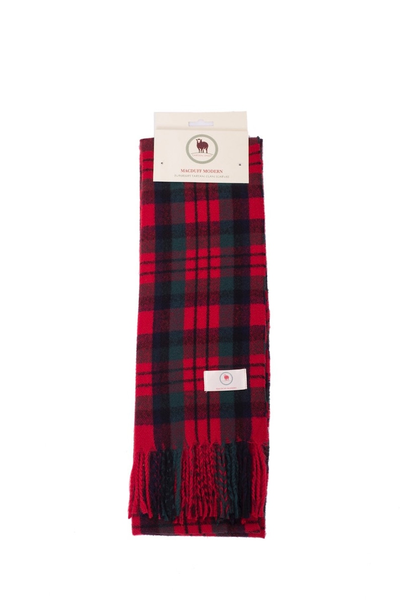 May include: Red and green plaid scarf with fringe. The scarf has a label that says "Macduff Modern Superior Cashmere Clan Scarf".