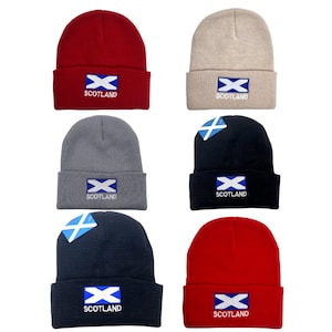 May include: Six knit beanies in different colours with the Scottish flag and the word "Scotland" embroidered on the front.