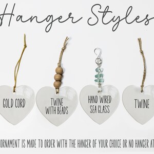 May include: Four white heart-shaped ornaments labeled Hanger Styles. The first has a gold cord, the second twine with beads, the third hand wired sea glass, and the fourth twine. Text reads: Each ornament is made to order with the hanger of your choice or no hanger at all.