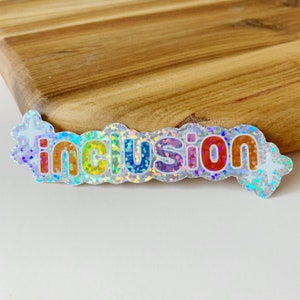 Inkluderande glitterklistermärke