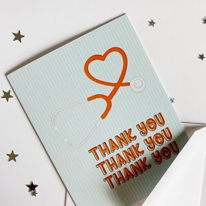 May include: A light blue card with a red heart and stethoscope design. The card says "Thank you" four times.