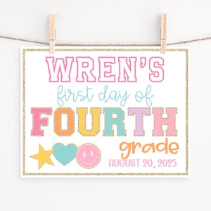May include: A colorful sign with the text "WREN'S first day of FOURTH grade AUGUST 20, 2025". The sign is decorated with a star, heart, and smiley face. The sign is hanging from a string with wooden clips.