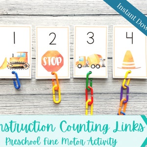May include: Four cards with construction-themed illustrations and numbers 1-4. Each card features a different image: a bulldozer, a stop sign, a cement truck, and a traffic cone. The cards are connected with colorful plastic links. Text on the cards reads "Construction Counting Links" and "Preschool Fine Motor Activity".