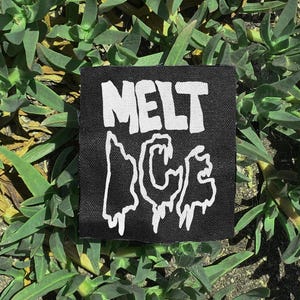 May include: A square black patch with the white text "MELT ICE" in a stylized font. The patch is surrounded by green plants.