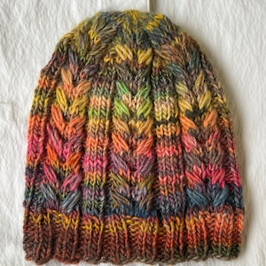 Hand-knitted women&#39;s hat. Cable-knitted women&#39;s wool hat. Hand-knitted wool hat. Green women&#39;s knitted hat. Colorful knitted hat.
