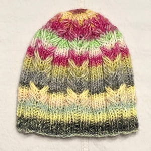 Hand-knitted multicolored wool hat. Warm, handmade hat. Women&#39;s hat knitted from high-quality wool. Knitted hat with colorful stripes.
