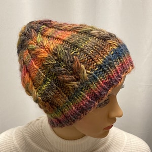 Hand-knitted women&#39;s hat. Cable-knitted woolen hat for women. Hand-knitted woolen hat. Green women&#39;s knitted hat. Colorful knitted hat