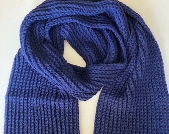 May include: A dark blue knitted scarf with a ribbed texture.