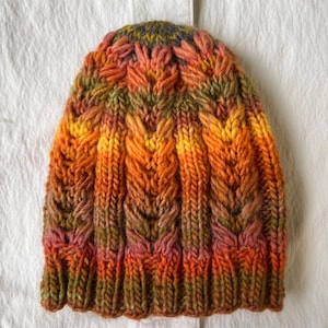 Hand-knitted multicolored wool hat. Warm, handmade hat. Women&#39;s hat knitted from high-quality wool. Knitted hat with colorful stripes.