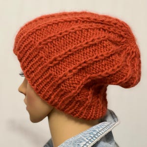 Hand-knitted women&#39;s hat made of merino wool. Knitted wool hat with a turn-up. Warm knitted hat for autumn. Attractive knitted winter hat.
