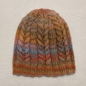 Women&#39;s hat knitted from high-quality wool. Hand-knitted wool hat for girls. Women&#39;s knitted hat taupe. Knitted hat in a colorful cable pattern
