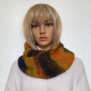 Knitted scarf made of colorful wool. Knitted loop with stripes. Hand-knitted alpaca scarf for women. Knitted wool scarf. Hand-knitted neck warmer
