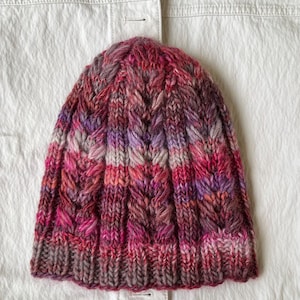 Hand-knitted multicolored wool hat. Warm, handmade hat. Women&#39;s hat knitted from high-quality wool. Knitted hat with colorful stripes.