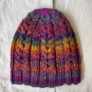 Hand-knitted multicolored wool hat. Warm, handmade hat. Women&#39;s hat knitted from high-quality wool. Knitted hat with colorful stripes.