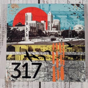 May include: A colorful collage featuring a cityscape with tall buildings, a red sun, and a large number "317" in black. The collage is made up of different textures and patterns, including a map, a cityscape, and a yellow and orange background.