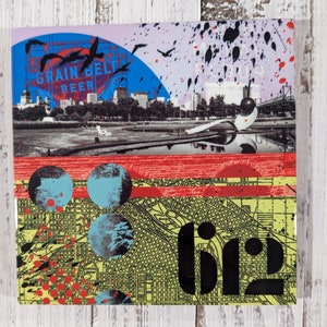 May include: A collage of images featuring a cityscape with the text "Grain Belt Beer" and a large spoon-like object. The bottom of the image features a map with the word "rip" in black text.