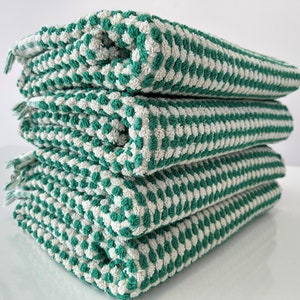 May include: A stack of four green and white striped kitchen towels. The towels are made of a soft, absorbent material and are perfect for drying dishes, hands, and surfaces.