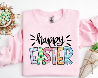 May include: A pink sweatshirt with the text "happy easter" in black lettering. The letters are decorated with colorful patterns.