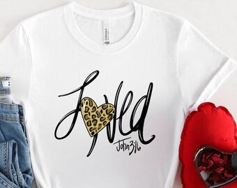 May include: White t-shirt with a black graphic that says "Loved" with a leopard print heart and the text "John 3:16" underneath.