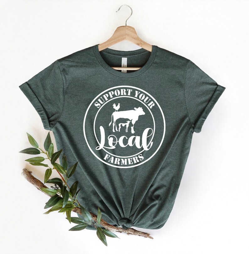 May include: A dark green t-shirt with a white circle graphic that says "Support Your Local Farmers" with a cow, calf, and chicken inside the circle.