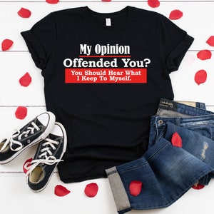 May include: Black t-shirt with white text that reads "My Opinion Offended You? You Should Hear What I Keep To Myself."