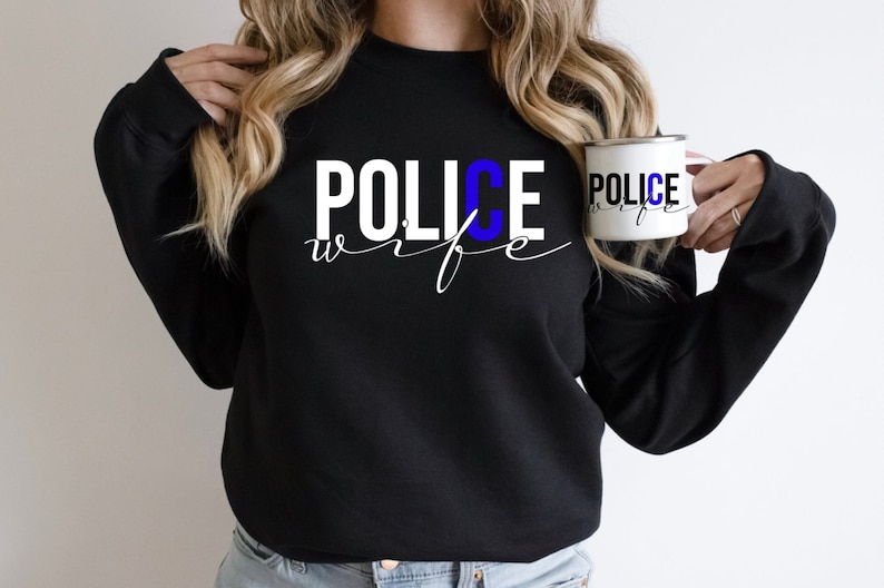 May include: Black sweatshirt with the text "POLICE wife" in white with a blue "C".