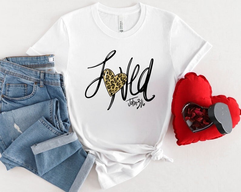 May include: White t-shirt with a black graphic that says "Loved" with a leopard print heart and the text "John 3:16" underneath.