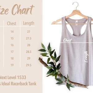 May include: Size chart for a racerback tank top with measurements in inches for chest and length. Sizes include XS, S, M, L, XL, and 2XL. The chart shows the measurements for each size. The tank top is light gray and is hanging on a wooden hanger.