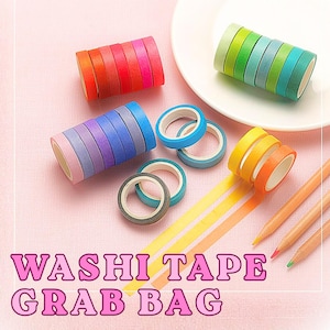 May include: A collection of colorful washi tape rolls in various shades of red, pink, orange, yellow, green, blue, and purple, arranged in stacks and individual rings, accompanied by three wooden pencils and the text WASHI TAPE GRAB BAG.