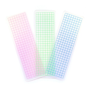 May include: Three clear plastic grid rulers with pink, green, and blue grid lines.