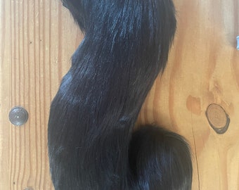 Curled long black fursuit tail