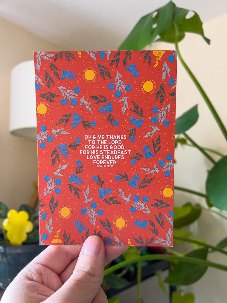 May include: A red card with a floral pattern and the text "OH GIVE THANKS TO THE LORD. FOR HE IS GOOD. FOR HIS STEADFAST LOVE ENDURES FOREVER! PSALM 18:29"
