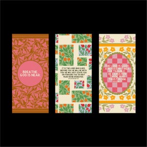 May include: Three rectangular art prints with inspirational quotes. The first features a pink circle with the words "BREATHE. GOD IS NEAR." The second has a floral pattern and text from Deuteronomy. The third has a pink and white checkered oval with text from Nahum.