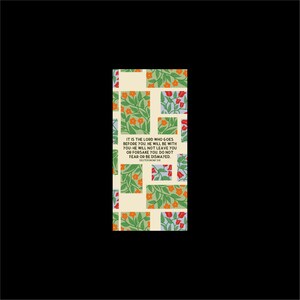May include: A rectangular bookmark with a floral pattern in green, orange, and red on a cream background. The text "IT IS THE LORD WHO GOES BEFORE YOU... DO NOT FEAR OR BE DISMAYED" is printed on the bookmark. The bookmark is set against a black background.