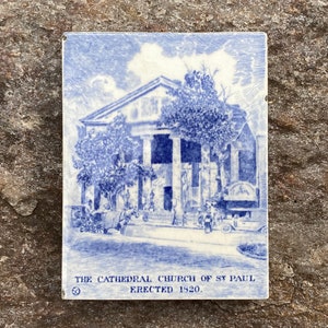 May include: A blue and white tile depicting a church building with the text "THE CATHEDRAL CHURCH OF ST. PAUL. ERECTED 1820."