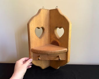 Vintage wooden corner shelf with heart cutouts and pegs