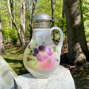 Antique milk glass syrup pitcher with metal lid and hand painted purple flower design