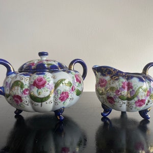 Antique hand painted Nippon creamer and sugar bowl set, Pink and green floral design with dark blue trim, Footed two handle sugar bowl