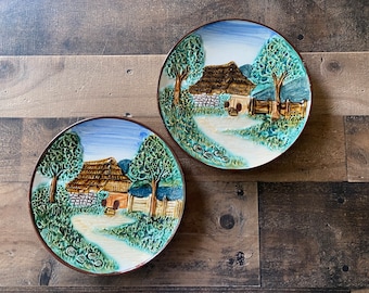Pair of vintage hanging wall plates with embossed cottage design