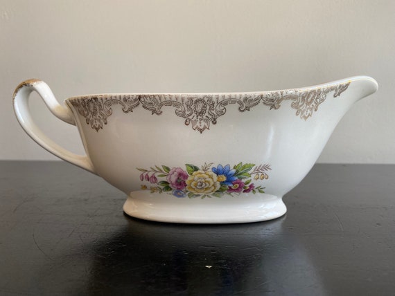 Vintage gravy boat with floral motif and gold filagree trim