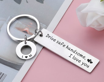 May include: Silver keychain with a charm that says "L ♥ M" and a tag that says "Drive safe handsome, I love you" with two small hearts.