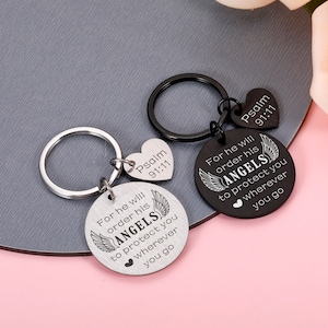 May include: Two silver keychains with a round charm that says "For he will order his angels to protect you wherever you go" and a heart charm that says "Psalm 91:11".